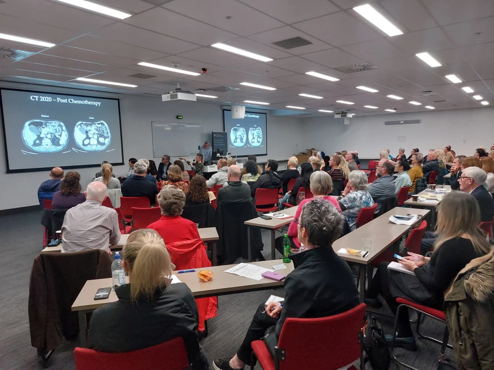 A packed room at the NECNZ Patient Education Day reviewing scan imagery
